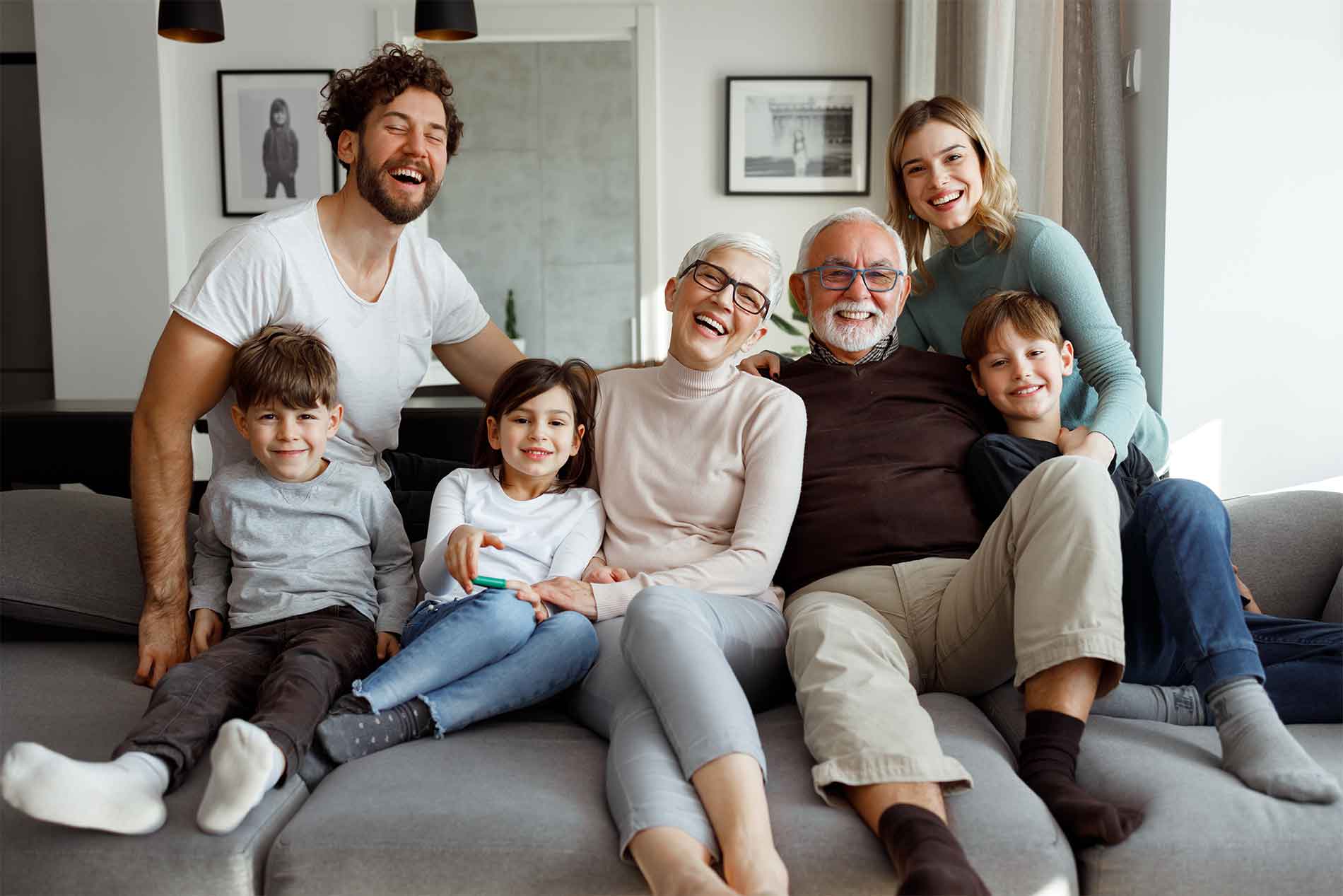 Family laughing together on the couch